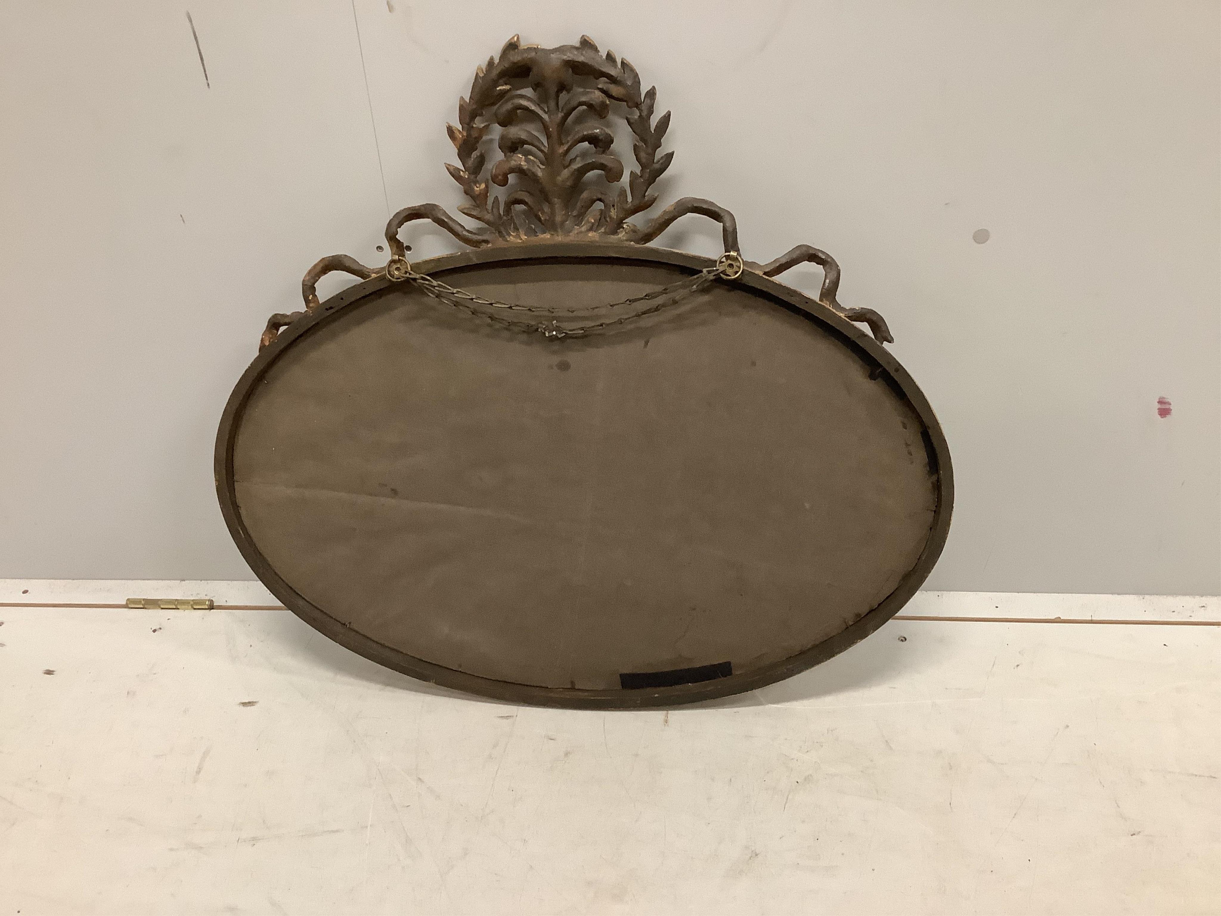 An Edwardian giltwood and composition oval marginal plate wall mirror, width 76cm, height 69cm. Condition good.